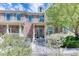 Inviting townhome exterior with a covered porch, lush landscaping, and charming details at 6365 Orion Ct # B, Arvada, CO 80403