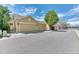 Street view of townhomes with attached garages and lovely curb appeal on a sunny day at 6365 Orion Ct # B, Arvada, CO 80403