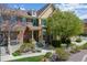 Charming brick townhome featuring manicured landscaping, inviting entrance, and sunny, bright curb appeal at 6365 Orion Ct # B, Arvada, CO 80403