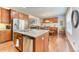 Eat-in kitchen with a stainless steel refrigerator, granite countertops and view into the dining area at 6365 Orion Ct # B, Arvada, CO 80403