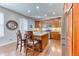 Well-equipped kitchen with hardwood floors, stainless steel appliances, granite counters, and central island at 6365 Orion Ct # B, Arvada, CO 80403