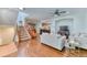 Spacious living room with hardwood floors, a cozy fireplace, and staircase leading to the second floor at 6365 Orion Ct # B, Arvada, CO 80403