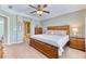 Bright main bedroom showcases a wood bed frame, neutral color palette, and en-suite bathroom for a luxurious feel at 6365 Orion Ct # B, Arvada, CO 80403