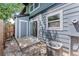 Back patio area featuring an air conditioning unit, stone landscaping, and backyard access to the property at 1459 S Pierce St, Lakewood, CO 80232