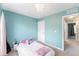 Bright bedroom with blue walls, large windows, and a cozy bed at 1459 S Pierce St, Lakewood, CO 80232