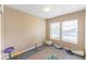 Neutral bedroom features hardwood floors and windows providing natural light at 1459 S Pierce St, Lakewood, CO 80232