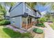 Two-story townhouse with a covered front porch, blue siding, and manicured landscaping at 1459 S Pierce St, Lakewood, CO 80232