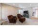 Cozy living room with plush chairs, soft carpet, and a modern entertainment center at 1459 S Pierce St, Lakewood, CO 80232