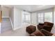 Inviting living room with carpet, front door, and staircase with an open floor plan at 1459 S Pierce St, Lakewood, CO 80232