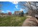 Spacious backyard featuring a green lawn, mature trees, and a trampoline for recreational activities at 5404 Fawn Ridge Way, Castle Rock, CO 80104
