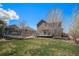 Expansive backyard with lush lawn, a trampoline, and a wooden deck for outdoor enjoyment at 5404 Fawn Ridge Way, Castle Rock, CO 80104