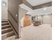 Finished basement with stairs leading down to a large open space, a sitting area, and hardwood doors at 5404 Fawn Ridge Way, Castle Rock, CO 80104
