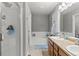 Bathroom with a double sink vanity, shower with glass door, and a soaking tub at 5404 Fawn Ridge Way, Castle Rock, CO 80104