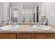 Primary bathroom featuring double sinks with chrome fixtures, light countertops, and decorative elements at 5404 Fawn Ridge Way, Castle Rock, CO 80104