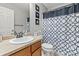 Bathroom featuring a vanity with a sink, a mirror, a toilet, and a shower with a patterned curtain at 5404 Fawn Ridge Way, Castle Rock, CO 80104
