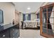 Spacious bedroom with dark wood furniture, plush carpeting, and an ample closet at 5404 Fawn Ridge Way, Castle Rock, CO 80104
