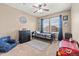 Bright bedroom with a ceiling fan, dresser, and bed by the window at 5404 Fawn Ridge Way, Castle Rock, CO 80104