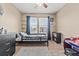 Bright bedroom with a ceiling fan, dresser, and bed by the window at 5404 Fawn Ridge Way, Castle Rock, CO 80104