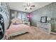 Bedroom with a decorated gray wall, carpeted floors, and a ceiling fan at 5404 Fawn Ridge Way, Castle Rock, CO 80104