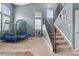 Inviting entryway features carpeted stairs with decorative metal handrail and neutral walls at 5404 Fawn Ridge Way, Castle Rock, CO 80104