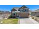 Charming two-story home with an attached two-car garage and a neatly kept front lawn at 5404 Fawn Ridge Way, Castle Rock, CO 80104
