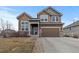 Charming two-story home with a two-car garage and well-manicured front yard at 5404 Fawn Ridge Way, Castle Rock, CO 80104