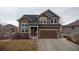 Charming two-story home with a well-manicured lawn, a two-car garage, and a welcoming front porch at 5404 Fawn Ridge Way, Castle Rock, CO 80104