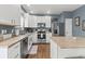 Modern kitchen featuring stainless steel appliances, an island, and ample cabinet space at 5404 Fawn Ridge Way, Castle Rock, CO 80104
