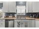 Charming kitchen featuring bright white cabinetry, stainless steel appliances, and a stainless steel sink at 5404 Fawn Ridge Way, Castle Rock, CO 80104