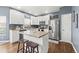 Well-lit kitchen with white cabinets, stainless steel appliances, and an island with seating at 5404 Fawn Ridge Way, Castle Rock, CO 80104