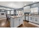 Open concept kitchen with island and white cabinetry, seamlessly flowing into the dining and living areas at 5404 Fawn Ridge Way, Castle Rock, CO 80104