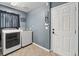 Well-equipped laundry room with modern washer and dryer units, plus easy outdoor access at 5404 Fawn Ridge Way, Castle Rock, CO 80104