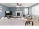 Bright living room with fireplace, neutral tones, and an open layout at 5404 Fawn Ridge Way, Castle Rock, CO 80104