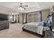 Large main bedroom with king bed, sitting area, and natural light creating a relaxing retreat at 5404 Fawn Ridge Way, Castle Rock, CO 80104