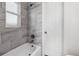 Charming bathroom with gray tile in shower and bath, with a bright window at 4401 W Mississippi Ave, Denver, CO 80219