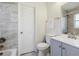 Charming bathroom features sleek tile, a shower and bath, a sink and grey cabinets at 4401 W Mississippi Ave, Denver, CO 80219