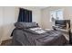 Bright bedroom with wood floors, a window, a view of the outside and a comfortable bed at 4401 W Mississippi Ave, Denver, CO 80219