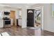 Bright entryway flowing into a modern kitchen with stainless steel appliances and sleek cabinetry at 4401 W Mississippi Ave, Denver, CO 80219
