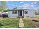 Charming home featuring a well-maintained front lawn and inviting entryway. Perfect for a cozy suburban lifestyle at 4401 W Mississippi Ave, Denver, CO 80219