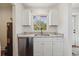 A charming kitchen nook features modern cabinets, granite countertops, stainless steel appliances, and ample natural light at 4401 W Mississippi Ave, Denver, CO 80219