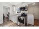 This modern kitchen features stainless steel appliances, granite countertops, and stylish wood flooring at 4401 W Mississippi Ave, Denver, CO 80219