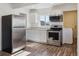 Modern kitchen with stainless steel appliances, white cabinets, and ample countertop space at 4401 W Mississippi Ave, Denver, CO 80219