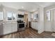 Well-lit kitchen featuring stainless steel appliances, white cabinets, and attractive granite countertops, a cook's dream at 4401 W Mississippi Ave, Denver, CO 80219