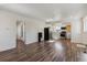 Bright living room featuring modern wood floors, white walls and an adjacent kitchen with stainless appliances at 4401 W Mississippi Ave, Denver, CO 80219