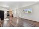 Bright and airy living room with stylish wood flooring and a modern kitchen nearby, perfect for entertaining at 4401 W Mississippi Ave, Denver, CO 80219