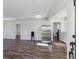 An open-concept space featuring wood floors, neutral walls, and a view to the kitchen and the laundry at 4401 W Mississippi Ave, Denver, CO 80219