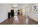 Spacious living room that flows into a modern kitchen, featuring stylish floors and ample natural light at 4401 W Mississippi Ave, Denver, CO 80219