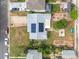 Aerial view of the home with solar panels, fenced yard, gardens, patio, and a detached garage at 1670 Oakland St, Aurora, CO 80010