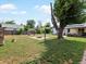 Spacious backyard includes a large tree, fire pit, and a well-maintained lawn at 1670 Oakland St, Aurora, CO 80010