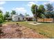 Expansive backyard with firepit, mature tree, and solar panels on the home's roof at 1670 Oakland St, Aurora, CO 80010